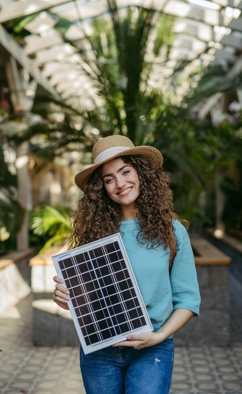 young-woman-in-botanical-garden-holding-solar-panel-concept-of-green-energy-.jpg